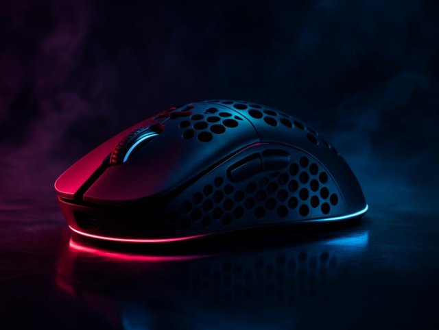 Honeycomb-shell gaming mouse in profile with red light glowing beneath it